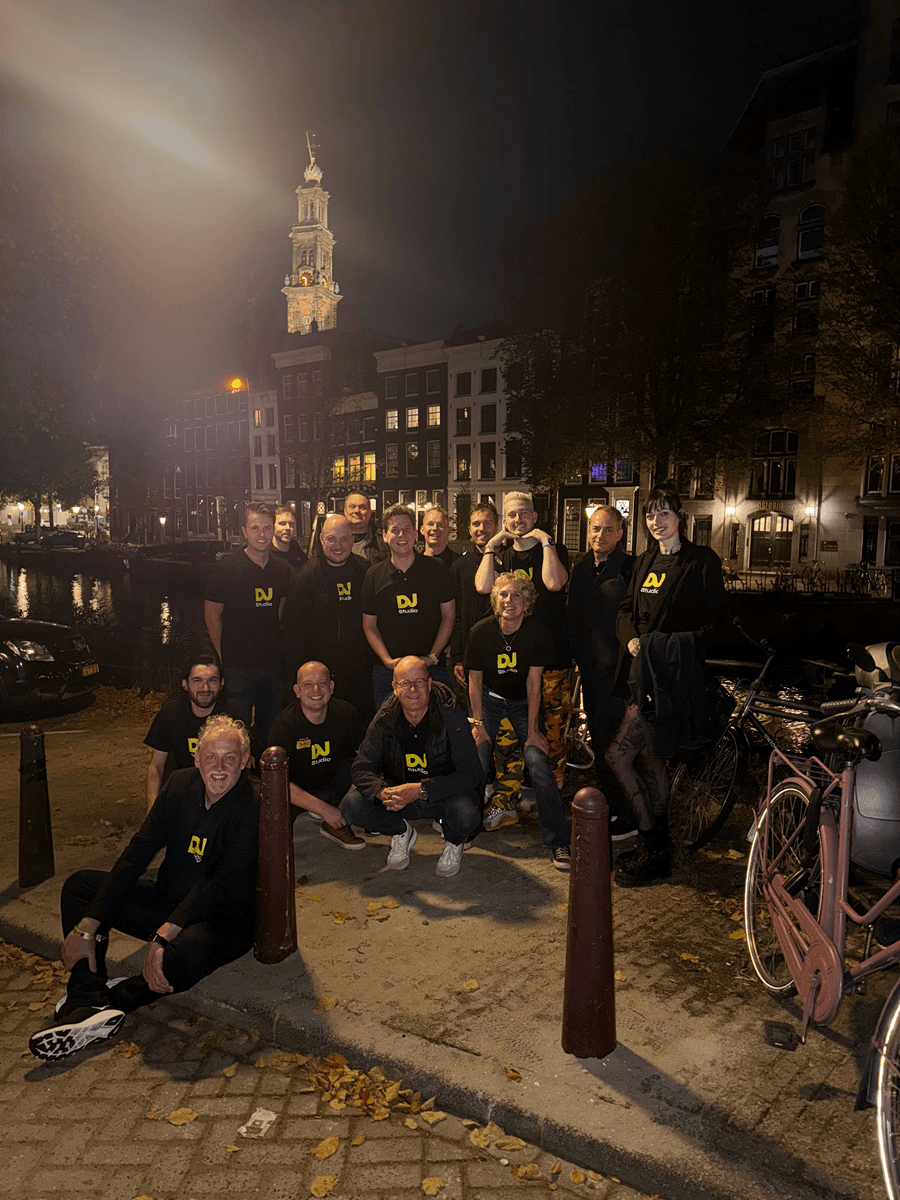 The DJ.Studio team photographed on an Amsterdam canal during a team meeting