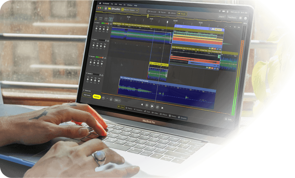 DJ creating a transition with stem separation on their laptop in DJ.Studio